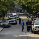 Pregnant Mom Among DEAD In Home Massacre Police officers secure a residential street with patrol cars and yellow tape