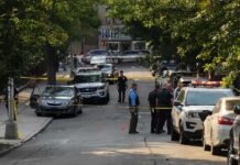 Pregnant Mom Among DEAD In Home Massacre Police officers secure a residential street with patrol cars and yellow tape