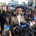 Mamdani’s Wife Glorifies Palestinian Terrorist Who Shot Down Plane Zohran Mamdani speaks at a press conference; Julia Bacha is visible among the crowd