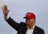 Trump Endorsed Candidate Caught Berating Him Donald Trump waving in a red cap