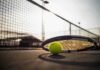 Tennis racket and ball on a court near the net