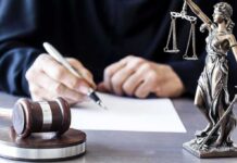 Body Armor Ban Ruled Unconstitutional – Major 2A Win Judge writing at desk with gavel and Lady Justice statue