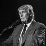 Naked Gold Trump Statue Appears in Government Office Donald Trump speaking at a microphone in a black-and-white photo