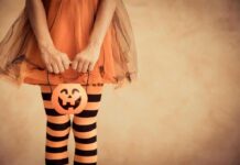 Halloween Boss Accused – More Women Come Forward Child in orange tutu holding a jack-o'-lantern bucket