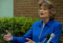 RINO Senator Endorses Dem Candidate – Turns On Party Lisa Murkowski speaking at an outdoor press conference with microphones in front