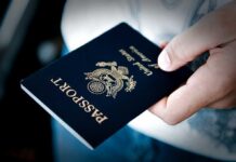 FBI SEIZE Omars Passport and Phone A person holding a United States passport with a dark background